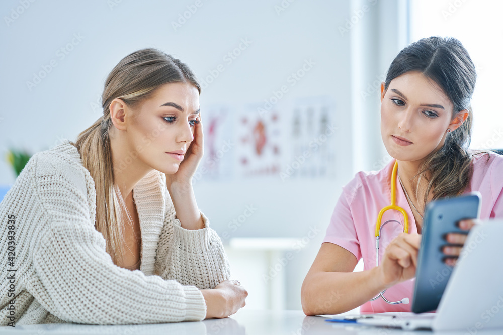 Doctor explaining diagnosis to her female patient Doctor explaining diagnosis to her female patient