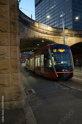 Light rail tram travelling under a tunnel