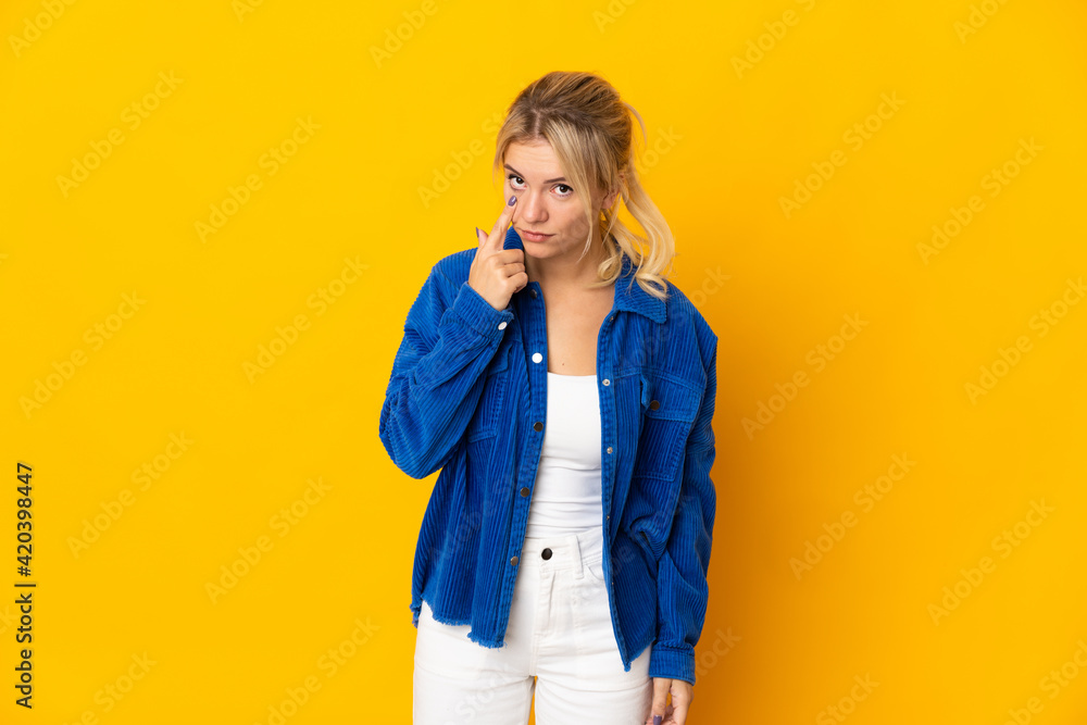 Young Russian woman isolated on yellow background showing something Young Russian woman isolated on yellow background showing something