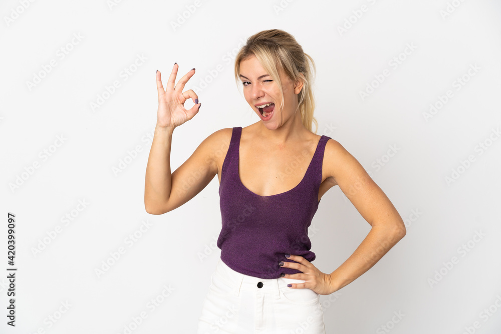 Young Russian woman isolated on white background showing ok sign with fingers