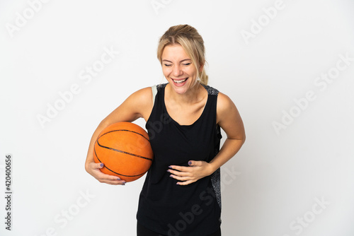 Young Russian woman playing basketball isolated on white background smiling a lot