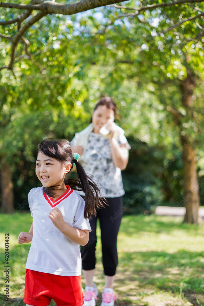 外でランニングをするお母さんと子供 外でランニングをするお母さんと子供