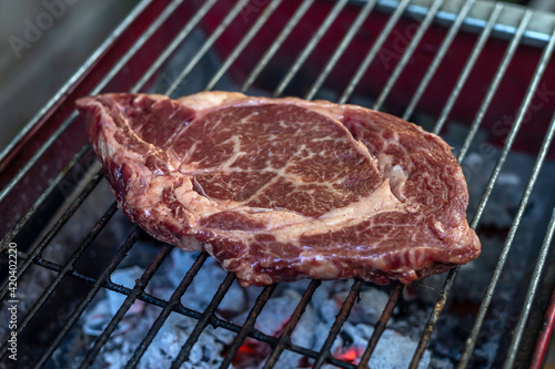 Tasty beef tenderloin steak with spices on the grill.