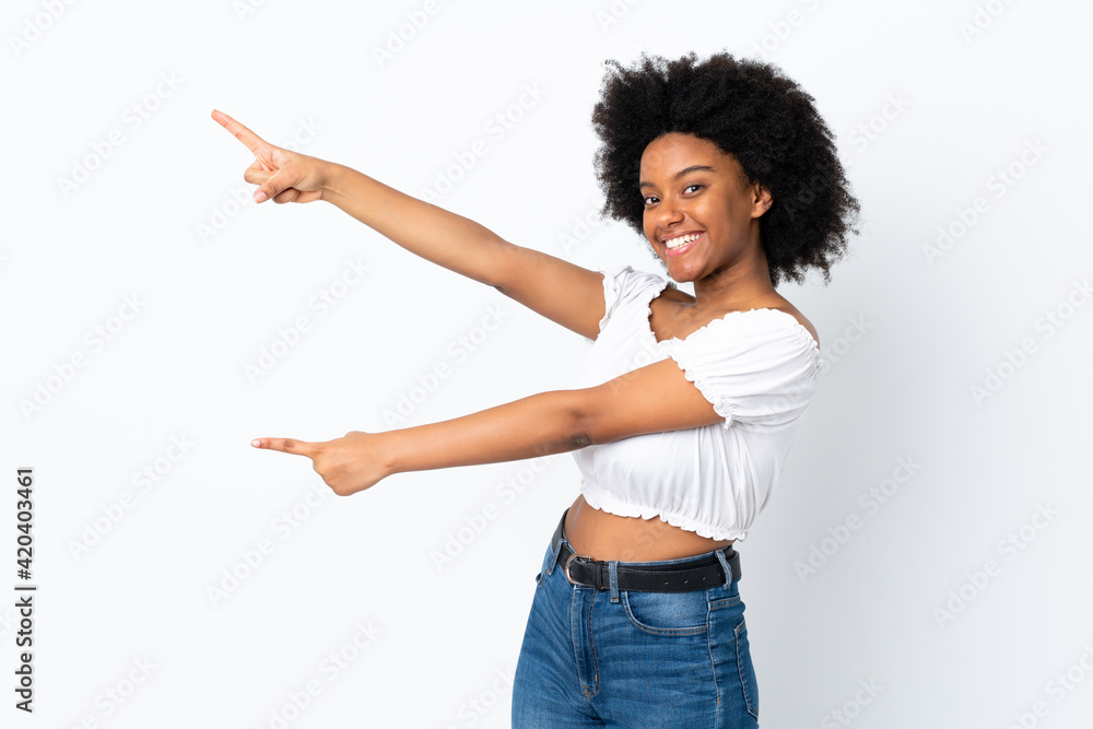 Young African American woman isolated on white background pointing finger to the side and presenting a product Young African American woman isolated on white background pointing finger to the side and presenting a product