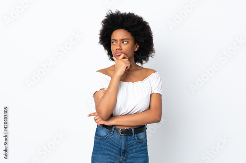 Young African American woman isolated on white background thinking an idea while looking up