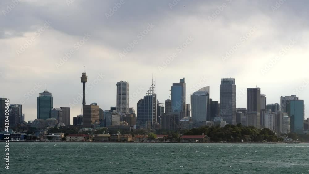 Sydney, Australia, the city center ,Harbor Bridge and the opera house from a boat on a cloudy day Sydney, Australia, the city center ,Harbor Bridge and the opera house from a boat on a cloudy day