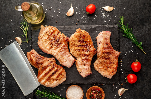 grilled pork steaks on stone background