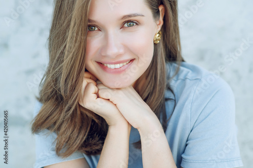 Beautiful smiling woman. Portrait of a young woman with regular features. High quality photo.