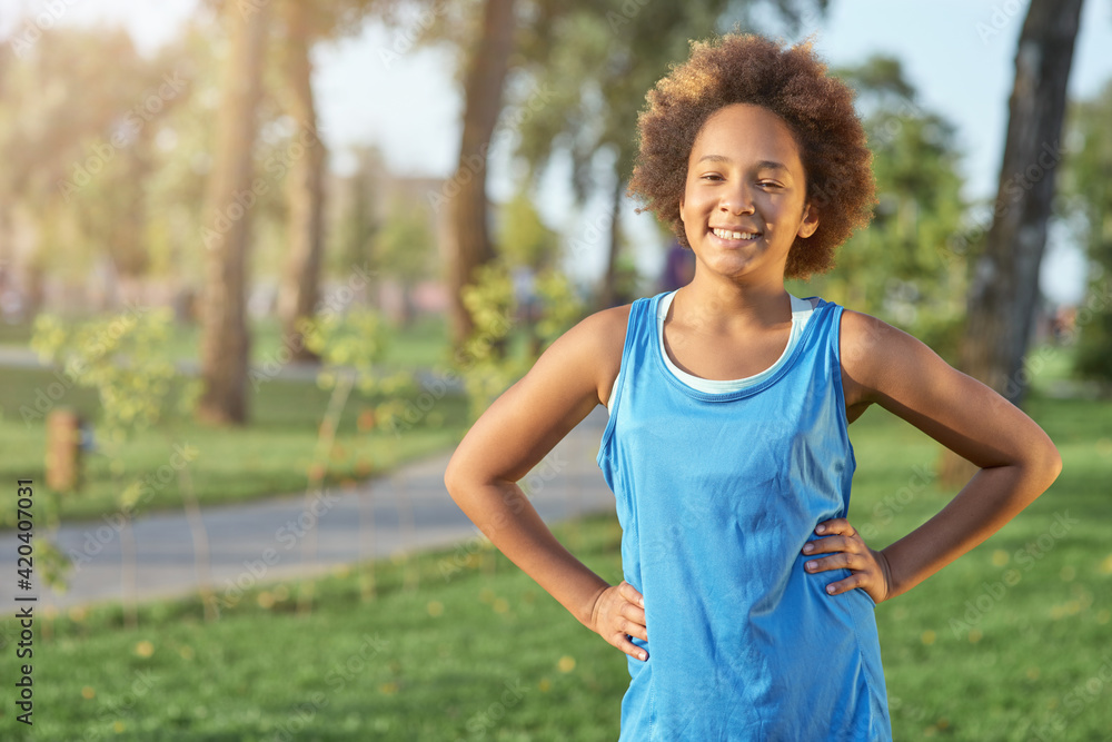Adorable Afro American girl standing on the street Adorable Afro American girl standing on the street