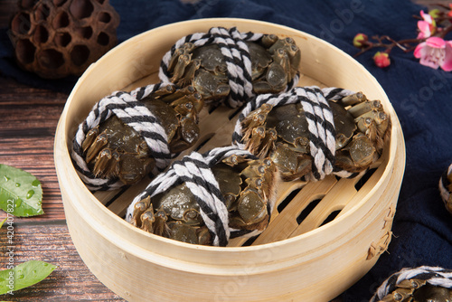 Raw Chinese mitten crab, shanghai hairy crab isolated on wooden background.