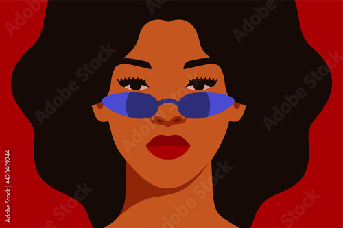 Young African American woman with curly black hair in blue sunglasses with reflection. Black strong girl on a red background, front view. Vector illustration