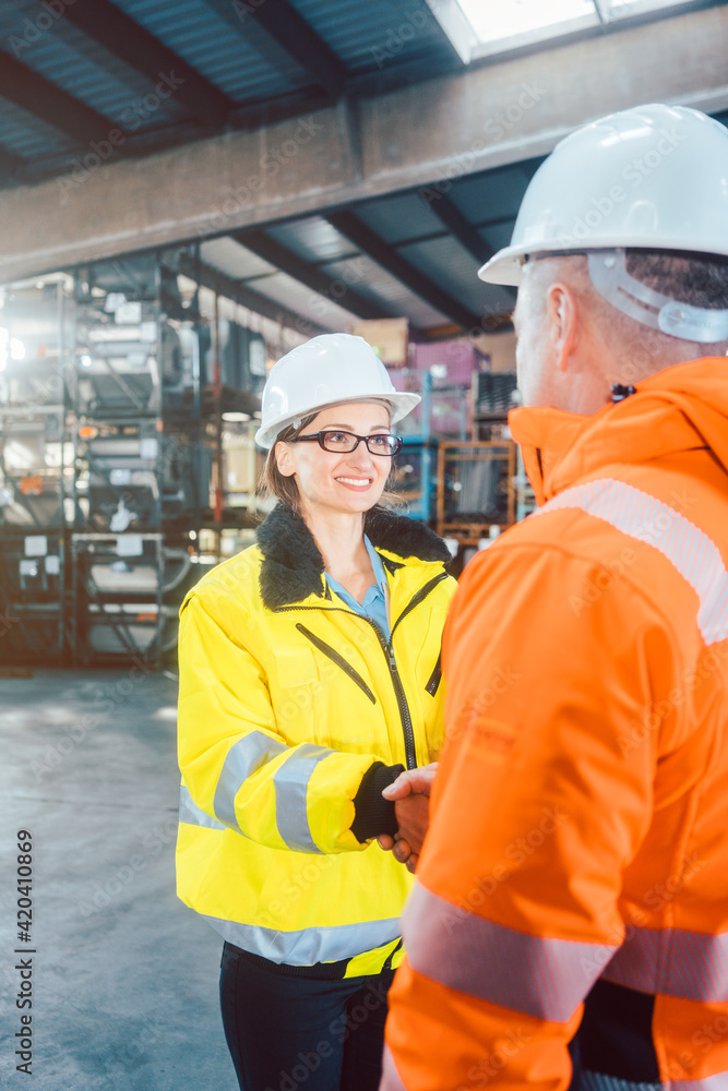 worker and customer in warehouse doing Handshake worker and customer in warehouse doing Handshake