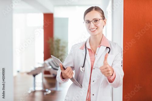 Doctor woman in her practice giving a thumbs up