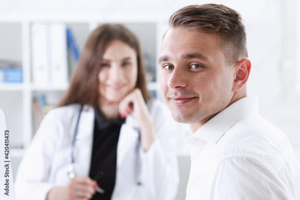 Satisfied happy handsome smiling male patient with doctor Satisfied happy handsome smiling male patient with doctor