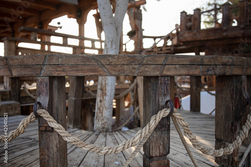 Принти на полотні Wooden handrails with intertwined rope close up.