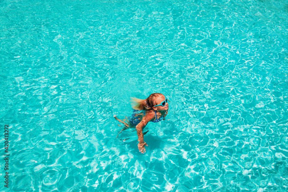 cute little girl swim at the pool, beach vacation