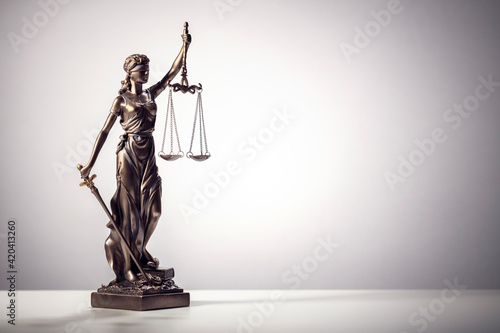 Legal and law concept statue of Lady Justice with scales of justice background photo