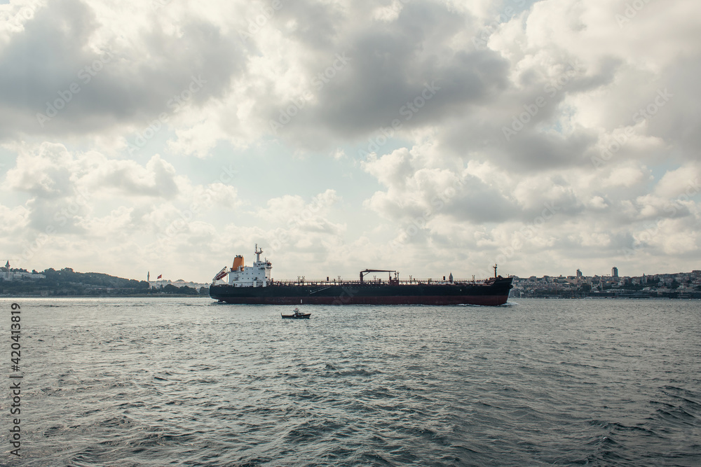 Cargo ship in sea with cloudy sky at background, Istanbul, Turkey