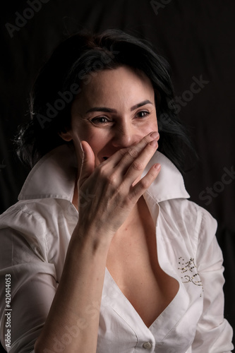 Wallpaper Mural Portrait of beautiful mature brunette woman dressed in white shirt isolated on black background, copy space Torontodigital.ca