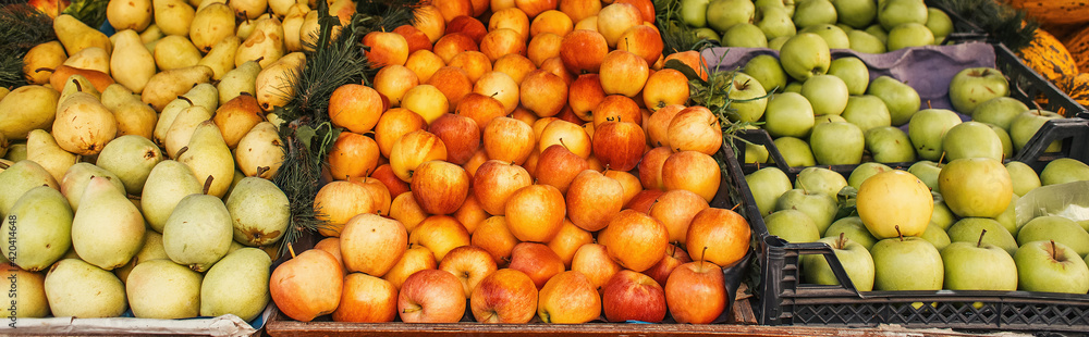 Ripe apples and pears on stall on street, banner