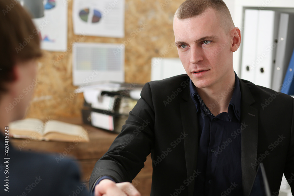 Fototapeta premium Smiling businessman shake hands as hello in office