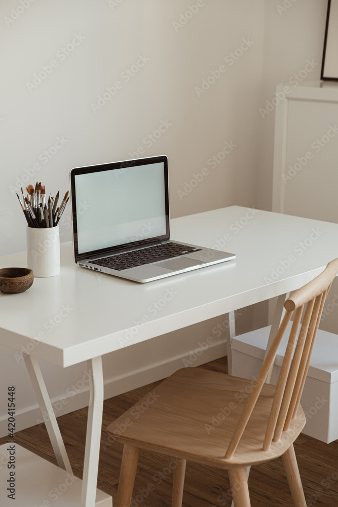 Laptop computer with blank screen on table. Aesthetic minimal office workspace interior design template with mockup copy space. Laptop computer with blank screen on table. Aesthetic minimal office workspace interior design template with mockup copy space.