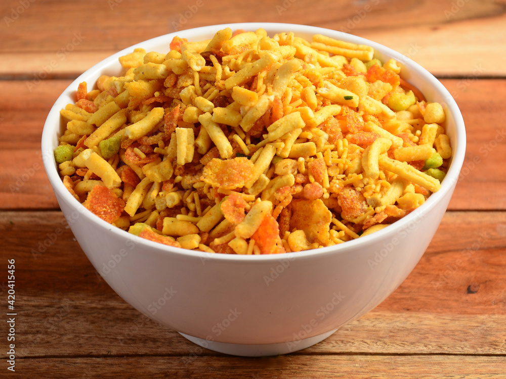 Indian traditional Namkeen Food Mixture or Navratna Mix Namkeen Also Know as Nimco, Namkin, Mixture ,chiwda or Nimko. Served in a bowl. selective focus Indian traditional Namkeen Food Mixture or Navratna Mix Namkeen Also Know as Nimco, Namkin, Mixture ,chiwda or Nimko. Served in a bowl. selective focus