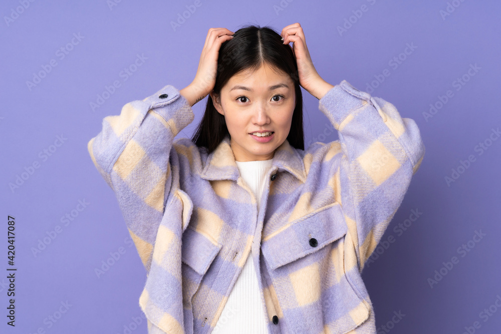 Young asian woman isolated on purple background doing nervous gesture Young asian woman isolated on purple background doing nervous gesture