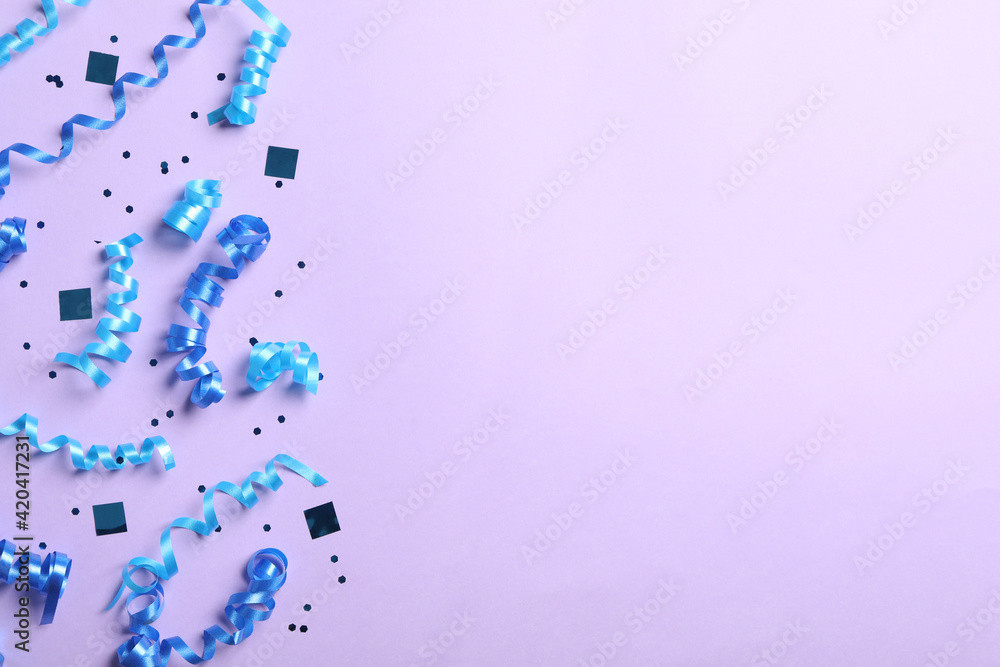 Blue serpentine streamers and confetti on light background, flat lay. Space for text