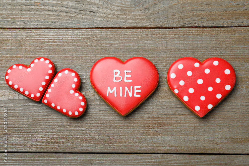 Decorated heart shaped cookies on wooden table, flat lay. Valentine's day treat Decorated heart shaped cookies on wooden table, flat lay. Valentine's day treat