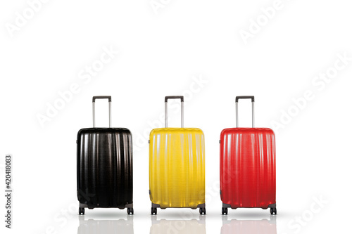 Belgium travel and holidays concept. Three travel suitcases with black, yellow and red colors that representing the Belgian national flag. Suitcases isolated on white. 