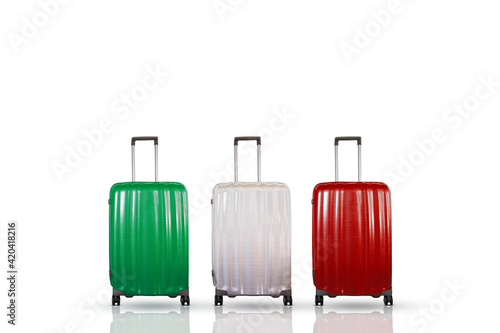 Italy holiday and tourism concept with three travel suitcases in green, white and red colors representing the Italian national flag. 