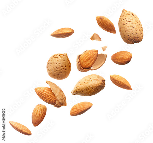 Tableau sur toile Group of almonds splashing over white background