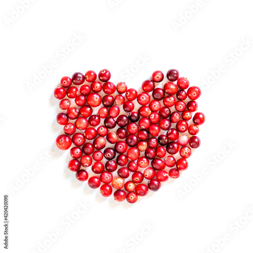 Natural forest cranberry. Heart shape red ripe cranberries macro view. white background. copy space. up view.
