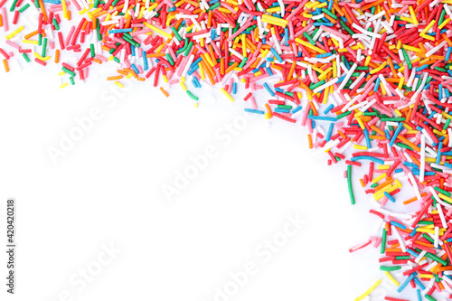 Colorful sprinkles on white background, top view. Confectionery decor