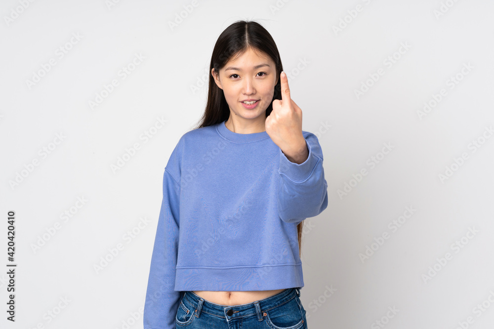 Young asian woman isolated on background doing coming gesture Young asian woman isolated on background doing coming gesture