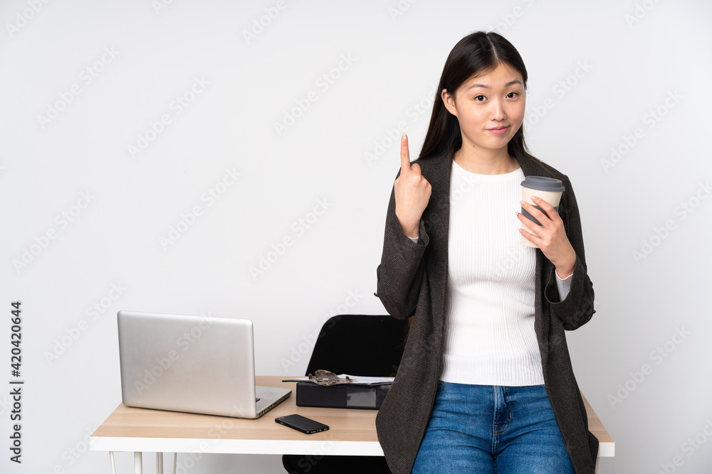 Business asian woman in her workplace isolated on white background pointing with the index finger a great idea Business asian woman in her workplace isolated on white background pointing with the index finger a great idea