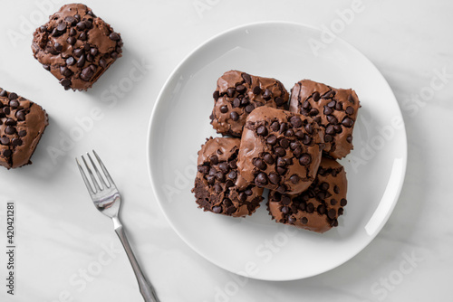 dark chocolate brownies topped by chocolate chips