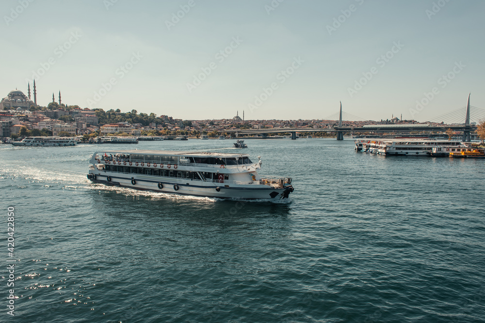 view of city from Bosphorus strait with floating and moored ships, Istanbul, Turkey