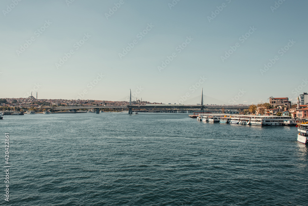 bridge over Bosphorus strait, and moored ships in Istanbul, Turkey