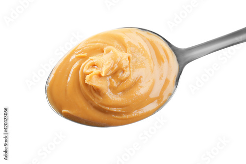 Delicious peanut butter in spoon isolated on white