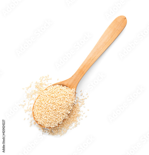 Wooden spoon with sesame seeds on white background, top view photo