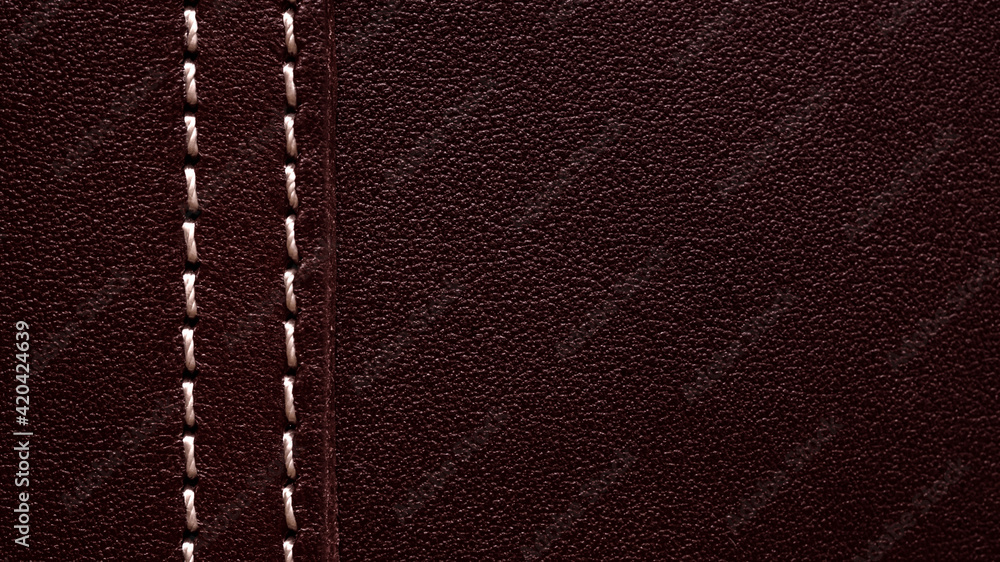 Background part of leather burgundy bag with white thread Background part of leather burgundy bag with white thread