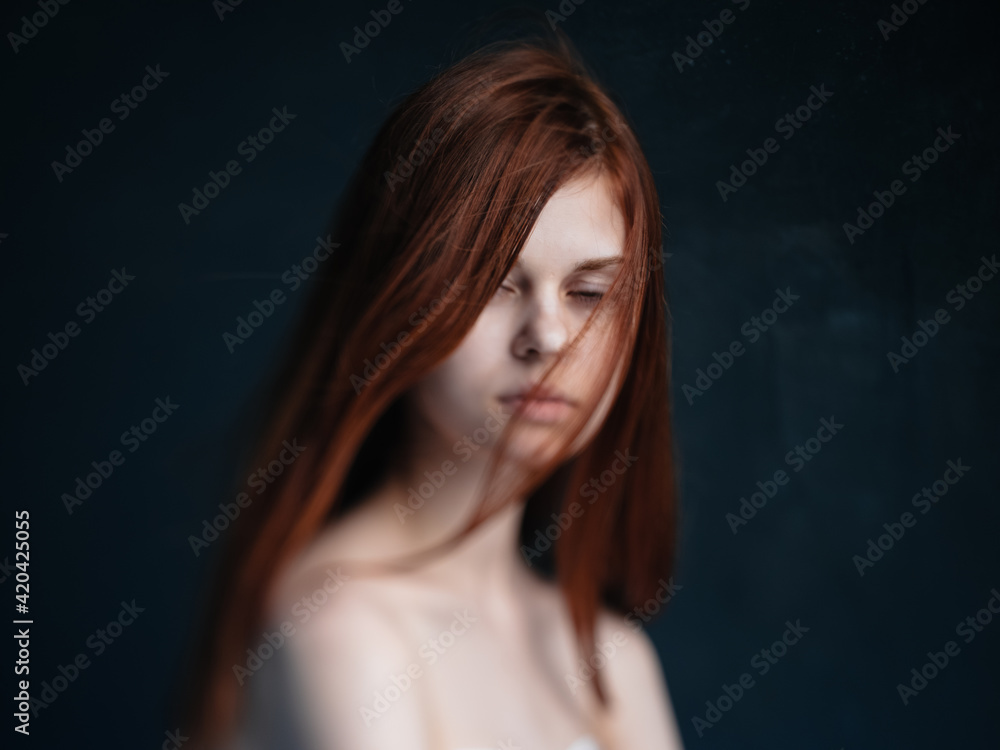 Sexy women red hair bared shoulders dark background model