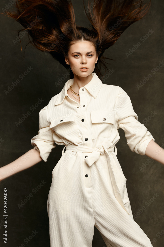 woman in overalls posing against dark background gesturing with hands cropped view woman in overalls posing against dark background gesturing with hands cropped view