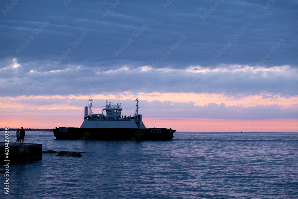Bay with passing ships in Sevastopol, Crimea at sunset. Bay with passing ships in Sevastopol, Crimea at sunset.