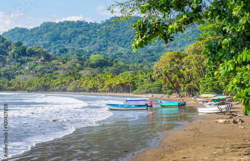Fishing boats on the beatiful beach. Exotic summer adventure, amazing nature of National Park of Costa Rica, Central America.