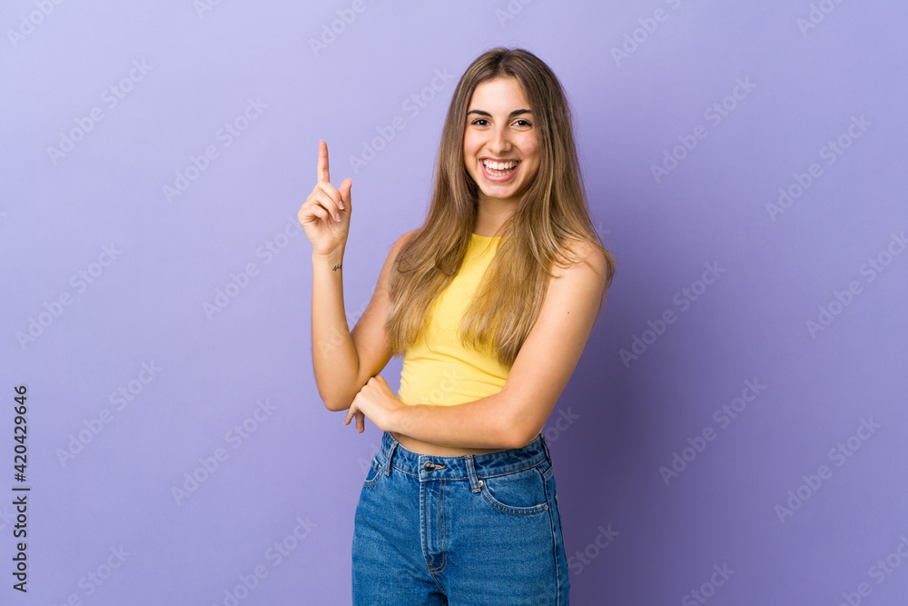 Young woman over isolated purple background pointing up a great idea Young woman over isolated purple background pointing up a great idea