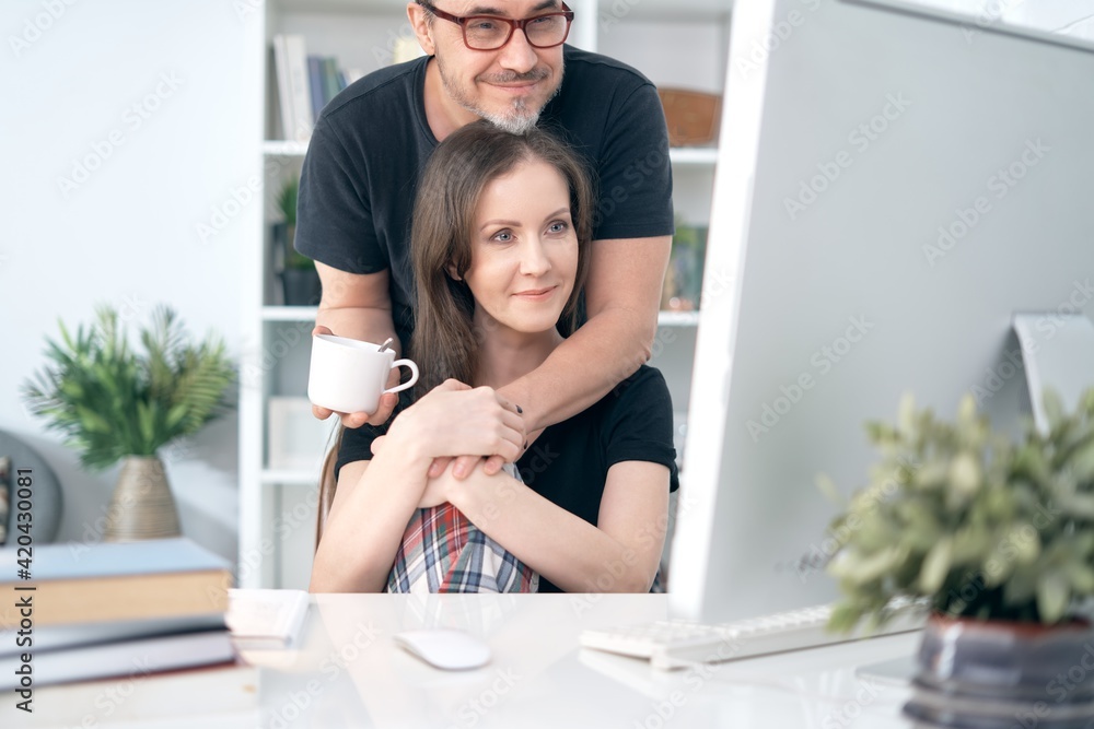 Happy loving couple drinking coffee at home in the morning. Happy loving couple drinking coffee at home in the morning.