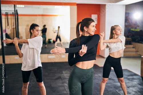 Three sporty ladies enjoying their morning stretching